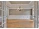 Dining room features hardwood floors, elegant chandelier, and classic wainscoting at 115 Robinwood Ct, Fayetteville, GA 30214