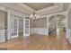 Spacious dining room with hardwood floors, an elegant chandelier, and access to kitchen at 115 Robinwood Ct, Fayetteville, GA 30214