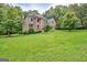 Stately brick home with a manicured front lawn and mature trees, offering classic curb appeal at 115 Robinwood Ct, Fayetteville, GA 30214