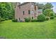 Brick home exterior with well-kept landscaping, including a green lawn and mature shrubs at 115 Robinwood Ct, Fayetteville, GA 30214