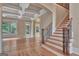 Foyer features hardwood floors, a staircase, and an arched entryway with classic trim at 115 Robinwood Ct, Fayetteville, GA 30214