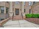 Inviting front entrance with brick steps and decorative columns at 115 Robinwood Ct, Fayetteville, GA 30214