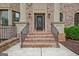Elegant front entrance with brick steps and metal railings at 115 Robinwood Ct, Fayetteville, GA 30214