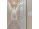 Hallway featuring neutral color palette and carpeting, plus a door to a room at 115 Robinwood Ct, Fayetteville, GA 30214