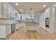 A spacious kitchen with white cabinets, granite countertops, and hardwood floors at 115 Robinwood Ct, Fayetteville, GA 30214