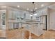 Well-lit kitchen with stainless steel appliances, island with bar seating, and window over the sink overlooking the outdoors at 115 Robinwood Ct, Fayetteville, GA 30214