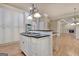 Kitchen with a cooktop island, stainless steel appliances, black countertops, and cabinetry for ample storage at 115 Robinwood Ct, Fayetteville, GA 30214