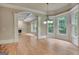 A living room offering both ample sunlight and an open-concept view of the kitchen at 115 Robinwood Ct, Fayetteville, GA 30214