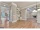 Open living room featuring hardwood floors, archway into the next room, and built-in shelves and desk at 115 Robinwood Ct, Fayetteville, GA 30214