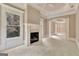 Bright living room with fireplace, white trim, columns, and tray ceiling with fan at 115 Robinwood Ct, Fayetteville, GA 30214