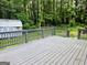 Backyard deck surrounded by lush greenery with a small storage shed at 5425 Herndon Blvd, Morrow, GA 30260
