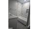 Bathroom with marble tile surround, bathtub, and a built-in shelf for extra storage at 5425 Herndon Blvd, Morrow, GA 30260