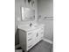 Bathroom featuring a vanity with white cabinetry, quartz countertop, and a framed mirror at 5425 Herndon Blvd, Morrow, GA 30260