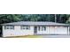 Charming single-story home featuring a freshly painted white brick exterior and an attached garage at 5425 Herndon Blvd, Morrow, GA 30260