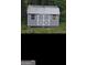 Outbuilding with gray siding, white trim, double doors with cross design, and two windows at 5425 Herndon Blvd, Morrow, GA 30260
