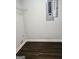 Storage room with dark laminate flooring and basic wire shelf at 5425 Herndon Blvd, Morrow, GA 30260