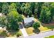 Aerial view of a two-story brick home with mature trees and landscaping at 1120 Bagwell Dr, Kennesaw, GA 30152