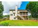 Large, well-maintained backyard with a two-story house, deck, lush grass, and a wooden fence at 1120 Bagwell Dr, Kennesaw, GA 30152