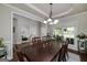 Elegant dining room featuring a large table, decorative lighting, and a view of the front yard at 1120 Bagwell Dr, Kennesaw, GA 30152
