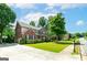 Beautiful brick home with manicured lawn, driveway, and mature landscaping, exuding curb appeal at 1120 Bagwell Dr, Kennesaw, GA 30152