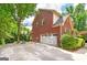 Brick home with a two-car garage and basketball hoop on a paved driveway at 1120 Bagwell Dr, Kennesaw, GA 30152