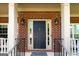 Close-up of a stylish front door with sidelights, a welcome mat, and decorative lanterns at 1120 Bagwell Dr, Kennesaw, GA 30152