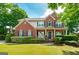 Beautiful two-story brick home with manicured lawn and charming front porch at 1120 Bagwell Dr, Kennesaw, GA 30152
