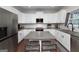 Bright kitchen features white cabinets, a gray countertop, stainless steel appliances, and bar seating at 1120 Bagwell Dr, Kennesaw, GA 30152