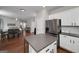 Kitchen with an island with bar stools and stainless steel appliances, open to the dining area and living room at 1120 Bagwell Dr, Kennesaw, GA 30152