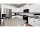 Bright kitchen with white cabinets, gray countertops, stainless steel appliances and hardwood floors at 1120 Bagwell Dr, Kennesaw, GA 30152