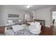 Spacious living room with hardwood floors, a gray sectional sofa, and a round swivel chair at 1120 Bagwell Dr, Kennesaw, GA 30152