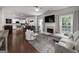 Open-concept living room with a fireplace, TV, and a view into the kitchen and dining area at 1120 Bagwell Dr, Kennesaw, GA 30152
