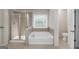 Luxurious main bathroom featuring a jetted tub, separate shower, and natural light at 1120 Bagwell Dr, Kennesaw, GA 30152