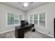 Home office with neutral walls, carpet, large windows with blinds, and a ceiling fan at 1120 Bagwell Dr, Kennesaw, GA 30152