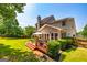 Exterior view of the two-story house, showcasing a spacious back deck, lawn, and mature landscaping, providing privacy at 306 Sandalin Ln, Peachtree City, GA 30269