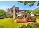 Backyard view of the house with a multi-tiered deck, seating, and landscaped lawn, perfect for outdoor living at 306 Sandalin Ln, Peachtree City, GA 30269