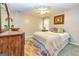 Comfortable bedroom with soft carpet, a ceiling fan, and a side table with lamp at 306 Sandalin Ln, Peachtree City, GA 30269