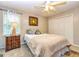 Comfortable bedroom featuring neutral walls, a ceiling fan, and a cozy bed with throw blanket at 306 Sandalin Ln, Peachtree City, GA 30269