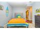 Bright bedroom with colorful bedding, decor, and ensuite bathroom access at 306 Sandalin Ln, Peachtree City, GA 30269