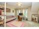 Well lit bonus room featuring a sofa, desk, and comfy office chair under a ceiling fan at 306 Sandalin Ln, Peachtree City, GA 30269
