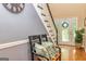 Inviting foyer with a staircase, decorative wreath, and a cozy bench with decorative pillows at 306 Sandalin Ln, Peachtree City, GA 30269