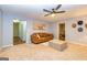 Spacious living room with a brown couch, ottoman, and unique artwork at 306 Sandalin Ln, Peachtree City, GA 30269