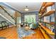Open concept living room with a staircase, bench seating, hardwood floors, and natural light at 306 Sandalin Ln, Peachtree City, GA 30269