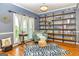 Cozy sitting area with hardwood floors, large windows, and custom open shelving at 306 Sandalin Ln, Peachtree City, GA 30269
