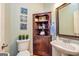 Charming powder room features decorative blue tile and a corner cabinet at 306 Sandalin Ln, Peachtree City, GA 30269