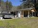 Spacious backyard features an auxiliary building and a vintage truck, perfect for storage or hobbies at 420 Dot Dr, South Fulton, GA 30349