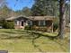 Traditional brick home with manicured lawn, showcasing timeless curb appeal and inviting entrance at 420 Dot Dr, South Fulton, GA 30349