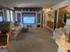 Spacious living room featuring a large entertainment center, comfortable seating, and neutral carpeting at 420 Dot Dr, South Fulton, GA 30349