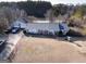 Aerial view of a one-story home with a detached garage and several vehicles in the driveway at 2353 Highway 155 N, Mcdonough, GA 30252