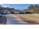 Aerial view of a one-story home with a detached garage, long driveway, and spacious yard at 2353 Highway 155 N, Mcdonough, GA 30252